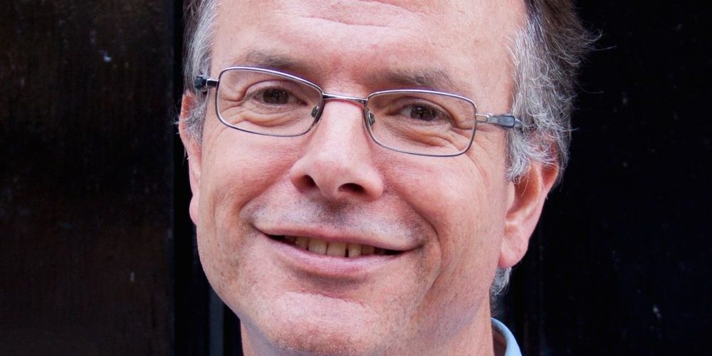 Headshot of David Clough smiling towards the camera.