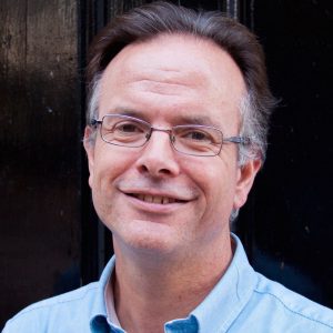 Headshot of David Clough smiling towards the camera.