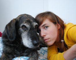 Picture of Eva Meijer and a canine friend looking towards the camera with their heads close together.
